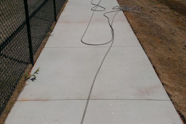 Cleaning rust stains off a concrete walkway.