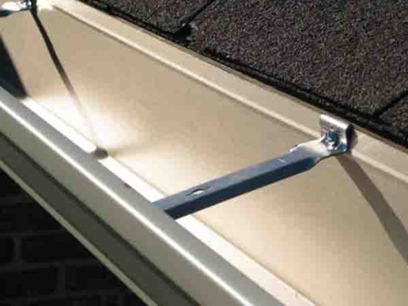 A brand new gutter secured to a home.