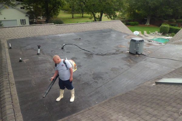 Prepping a roof to be cleaned.
