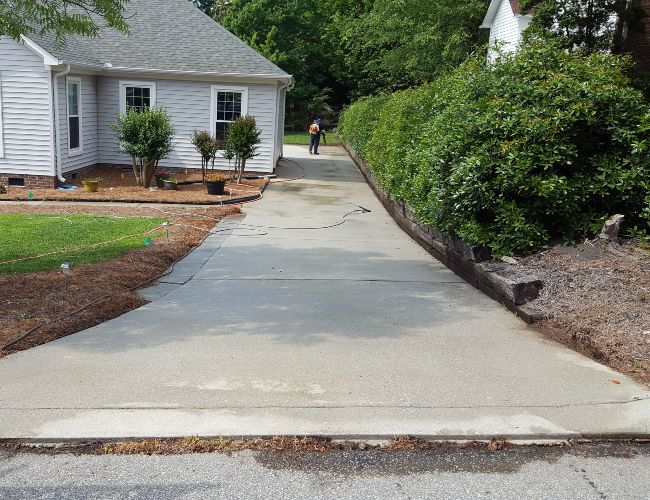 After a professional concrete driveway cleaning service.